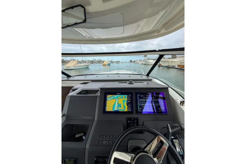Slide: The Image of Interior view of 2023 Nimbus Tender 11 yacht cockpit with navigation screens. - 12