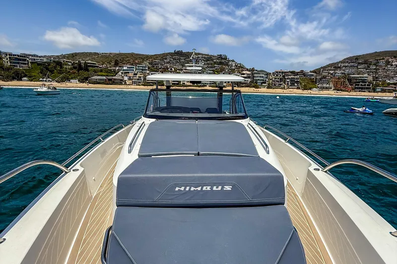 Slide: The Image of 2023 Nimbus Tender 11 yacht on blue ocean near scenic coastline. - 13