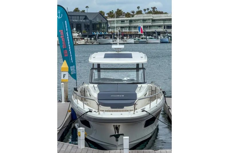 Slide: The Image of 2023 Nimbus Tender 11 docked at marina with rental sign in background. - 15