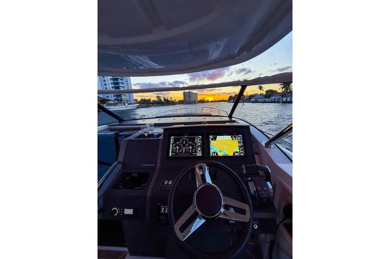 Slide: The Image of Cockpit view of 2023 Nimbus Tender 11 boat at sunset on the water. - 21