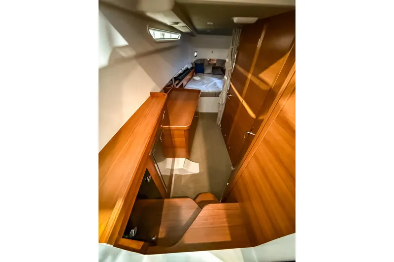 Slide: The Image of 2023 Nimbus Tender 11 interior with wooden cabinetry and cozy sleeping area. - 26