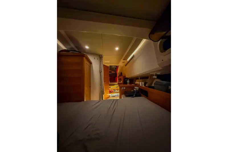 Slide: The Image of Interior of 2023 Nimbus Tender 11 boat cabin, featuring cozy sleeping area and storage. - 27