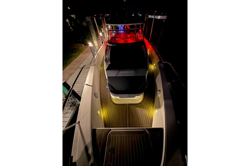 Slide: The Image of 2023 Nimbus Tender 11 yacht illuminated at night with ambient lighting. - 28