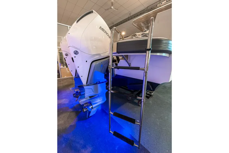 Slide: The Image of 2023 Nimbus Tender 11 boat with Mercury outboard engine and ladder, illuminated by blue light. - 29