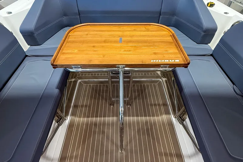 Slide: The Image of Luxurious seating area on 2023 Nimbus Tender 11 with wooden table and blue cushions. - 31