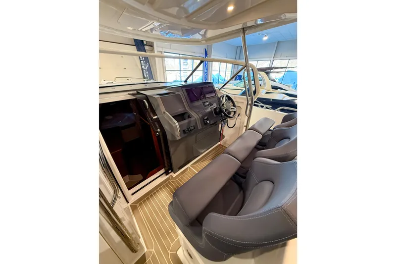 Slide: The Image of Interior of 2023 Nimbus Tender 11 boat with modern helm and seating. - 33