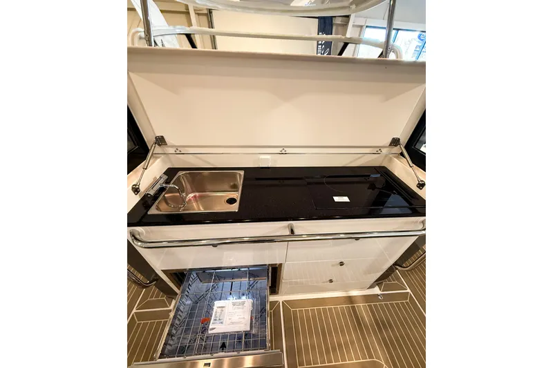 Slide: The Image of Modern kitchen area on 2023 Nimbus Tender 11 boat with sink and cooktop. - 34