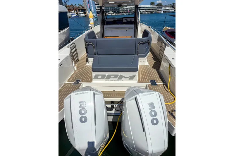 Slide: The Image of 2023 Nimbus Tender 11 boat with dual Mercury 300 engines, docked in Newport Beach. - 7