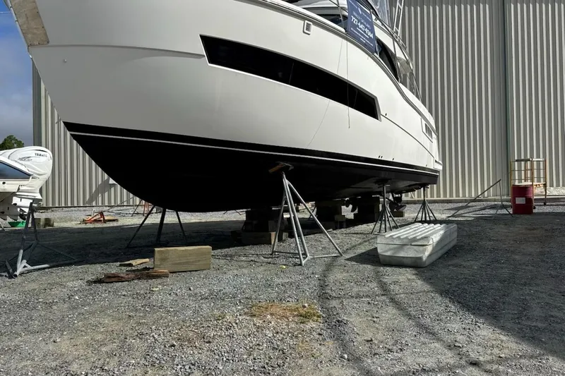 Slide: The Image of 2020 Carver 36 Command Bridge yacht on stands in a boatyard. - 120