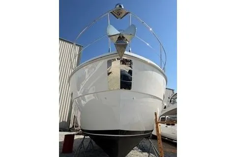 Slide: The Image of 2020 Carver 36 Command Bridge yacht, docked, front view, clear blue sky. - 125