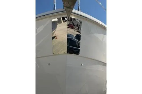 Slide: The Image of 2020 Carver 36 Command Bridge yacht, front view, docked under clear blue sky. - 126