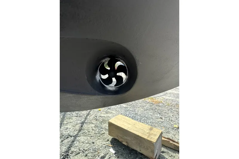Slide: The Image of Close-up of a 2020 Carver 36 Command Bridge boat thruster on a gravel surface. - 119