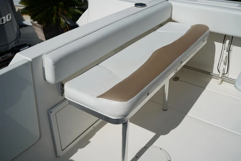 Slide: The Image of 2014 Edgewater 245CC boat with cushioned seating and sleek design. - 13