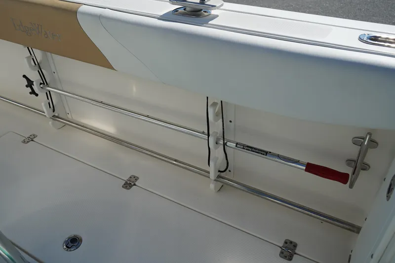 Slide: The Image of 2014 Edgewater 245CC boat interior with rod holder and storage compartment. - 20