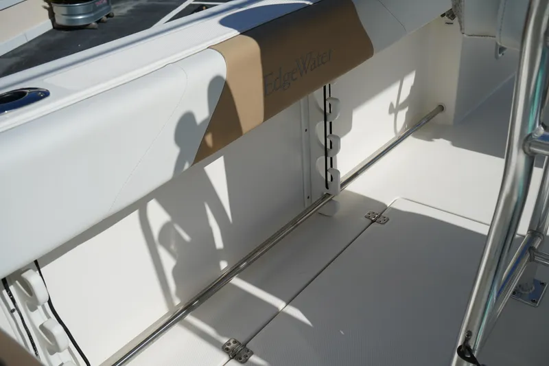 Slide: The Image of 2014 Edgewater 245CC boat interior with seating and storage area. - 21