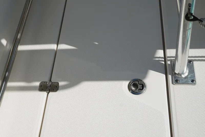 Slide: The Image of 2014 Edgewater 245CC boat deck with stainless steel fittings and textured surface. - 23