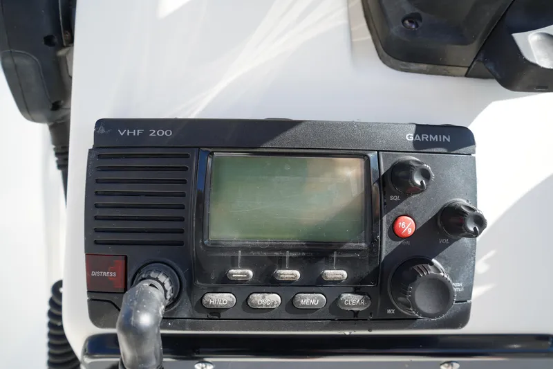 Slide: The Image of Garmin VHF 200 radio on 2014 Edgewater 245CC boat dashboard. - 30