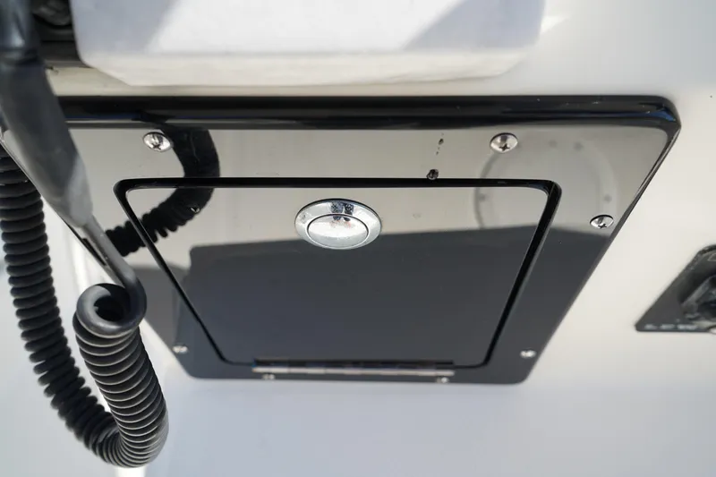 Slide: The Image of Edgewater 245CC 2014 boat console with black panel and coiled cable. - 33