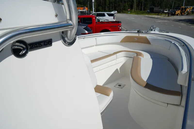 Slide: The Image of 2014 Edgewater 245CC boat interior with cushioned seating and stainless steel details. - 38