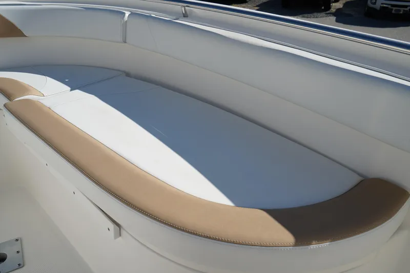 Slide: The Image of 2014 Edgewater 245CC boat interior with white and tan seating. - 42