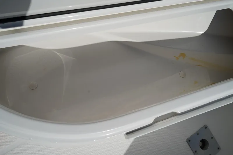 Slide: The Image of Open storage compartment on a 2014 Edgewater 245CC boat, showing interior details. - 46