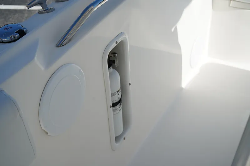 Slide: The Image of 2014 Edgewater 245CC boat interior with fire extinguisher compartment. - 47