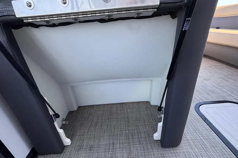 Slide: The Image of Interior view of Viaggio Z24U 2026 boat, featuring storage compartment and carpeted flooring. - 24