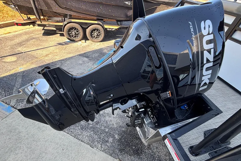 Slide: The Image of Black Suzuki outboard motor on a Viaggio Z24U boat, 2026 model, parked on a trailer. - 30