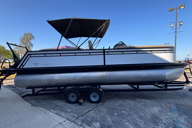 Slide: The Image of 2026 Viaggio Z24U pontoon boat on trailer, featuring sleek design and canopy. - 32