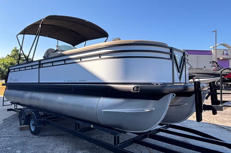 Slide: The Image of 2026 Viaggio Z24U pontoon boat on trailer, featuring sleek design and canopy. - 33