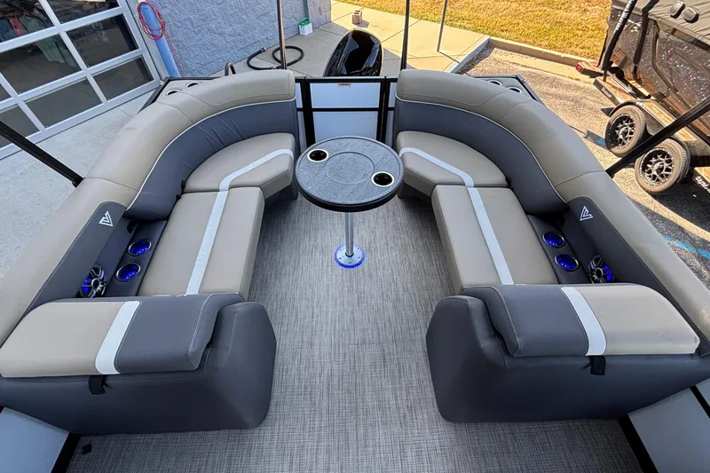 Slide: The Image of Luxurious seating area on 2026 Viaggio Z24U pontoon boat with round table and cup holders. - 7