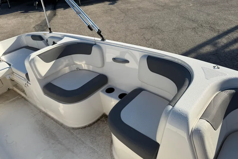 Slide: The Image of 2023 Bayliner Element E18 boat interior with cushioned seating and cup holders. - 11