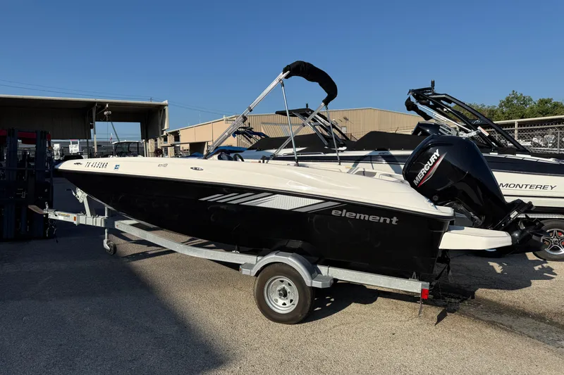 Slide: The Image of 2023 Bayliner Element E18 boat on trailer, outdoor dealership display. - 14