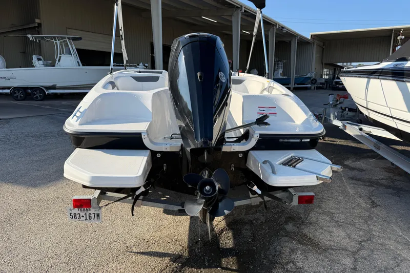 Slide: The Image of 2023 Bayliner Element E18 boat with outboard motor, parked in a marina. - 15