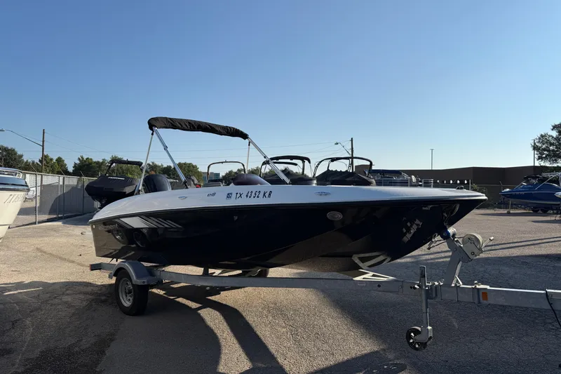 Slide: The Image of 2023 Bayliner Element E18 boat on trailer in outdoor lot. - 5