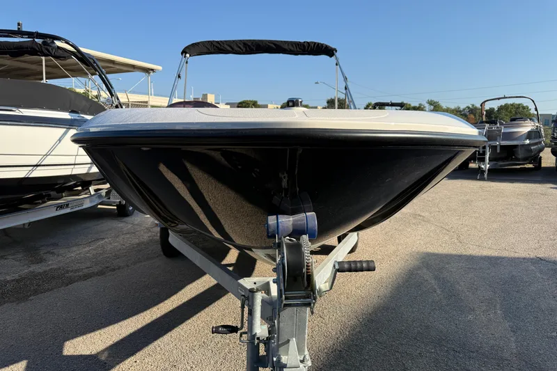 Slide: The Image of 2023 Bayliner Element E18 boat on trailer, parked outdoors under clear sky. - 6