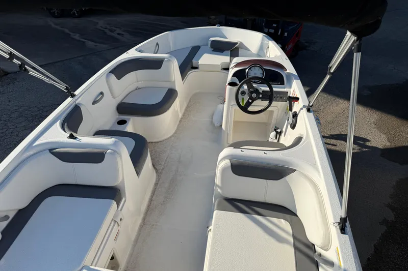 Slide: The Image of 2023 Bayliner Element E18 boat interior with seating and steering wheel. - 8