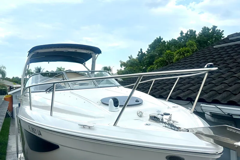Slide: The Image of 2025 Regal 26 XO boat with sleek design, docked near a house. - 1