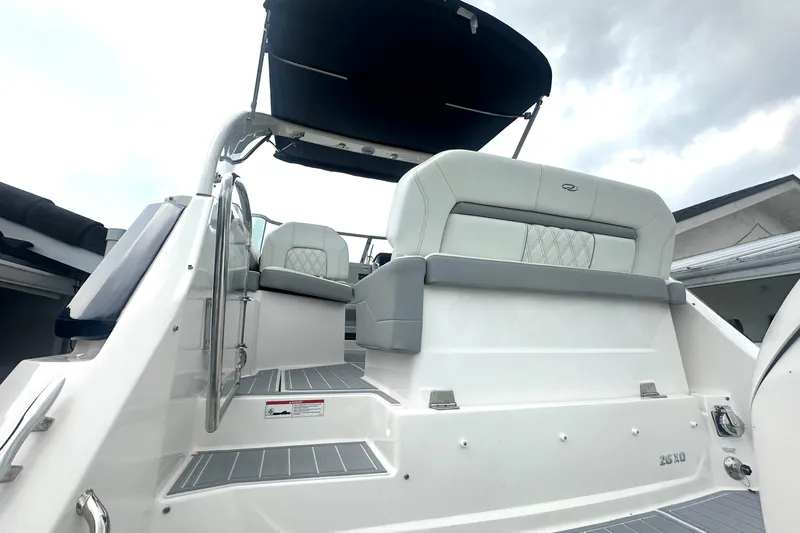 Slide: The Image of 2025 Regal 26 XO boat interior with cushioned seating and sleek design. - 13