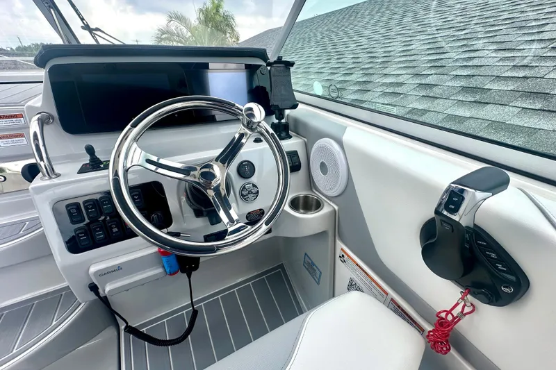 Slide: The Image of 2025 Regal 26 XO boat helm with modern controls and steering wheel. - 32
