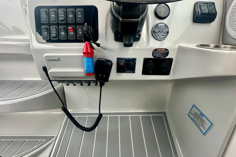 Slide: The Image of Control panel of 2025 Regal 26 XO boat with Garmin electronics and switches. - 34