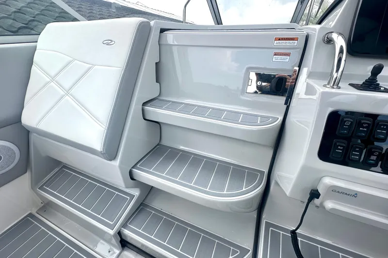 Slide: The Image of Interior of 2025 Regal 26 XO boat, featuring sleek seating and control panel. - 39