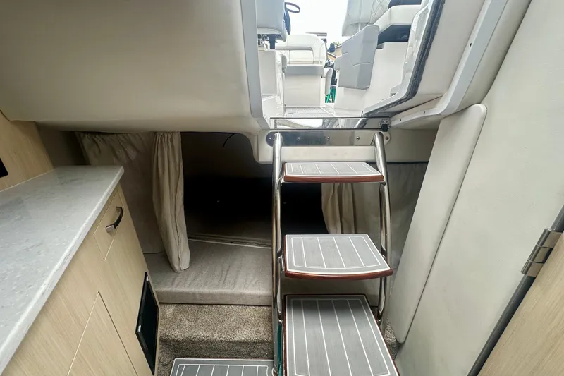 Slide: The Image of Interior of 2025 Regal 26 XO boat with stairs and cabin area. - 40