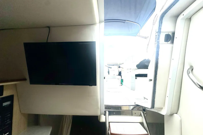 Slide: The Image of Interior view of 2025 Regal 26 XO boat with TV and open cabin door. - 41