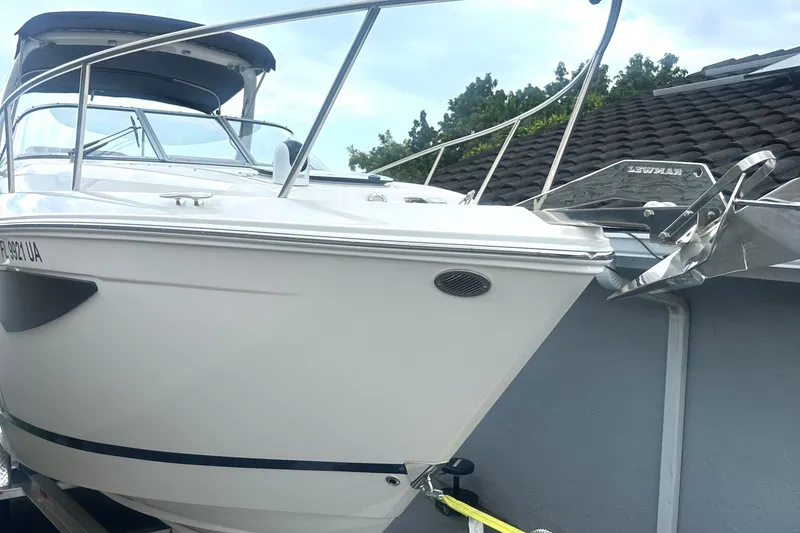 Slide: The Image of 2025 Regal 26 XO boat with sleek design, docked near a house. - 5