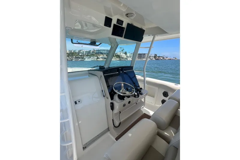 Slide: The Image of 2019 Boston Whaler 380 Outrage helm with modern controls and ocean view. - 1