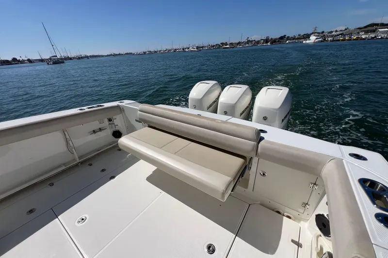 Slide: The Image of 2019 Boston Whaler 380 Outrage boat with triple Mercury engines on open water. - 10
