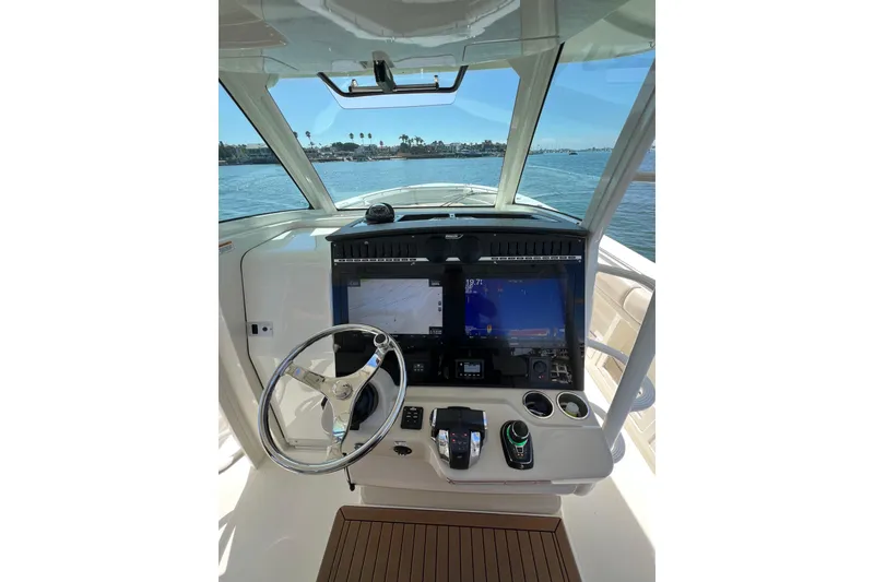 Slide: The Image of 2019 Boston Whaler 380 Outrage helm with advanced navigation displays and controls. - 15