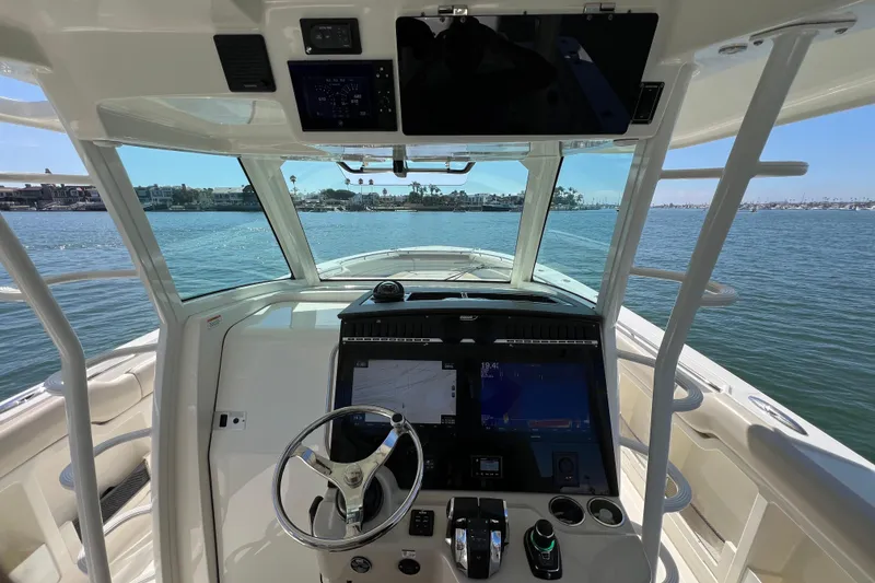 Slide: The Image of 2019 Boston Whaler 380 Outrage helm with advanced navigation system on open water. - 16