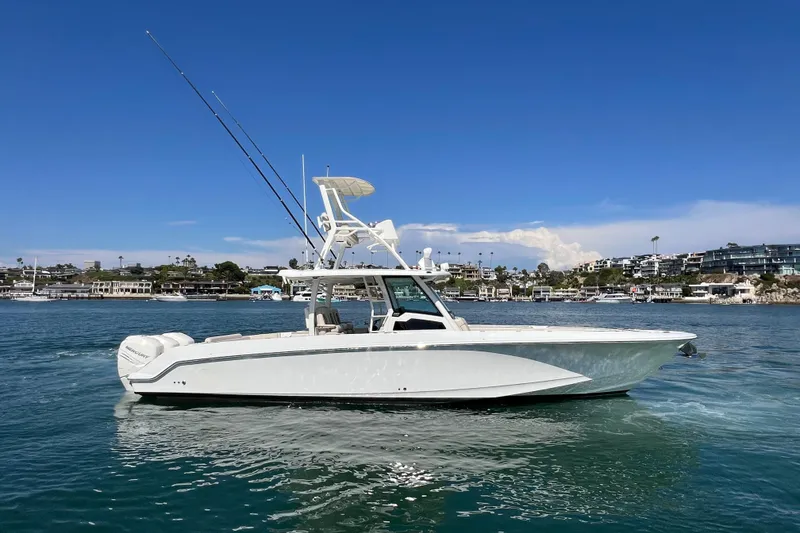 Slide: The Image of 2019 Boston Whaler 380 Outrage boat on calm water, clear sky background. - 21